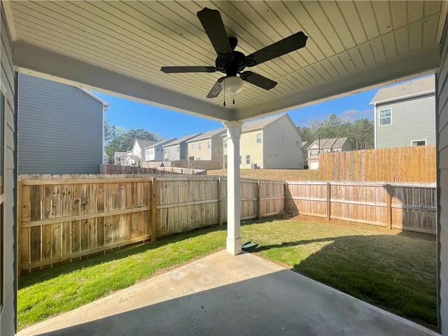 a view of a backyard with wooden fence