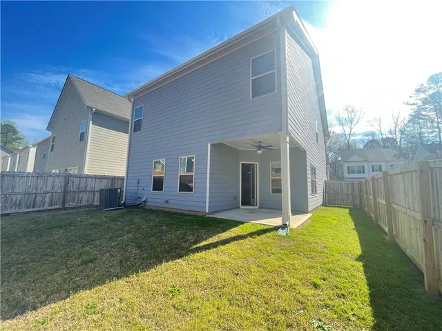 a view of a house with backyard and porch