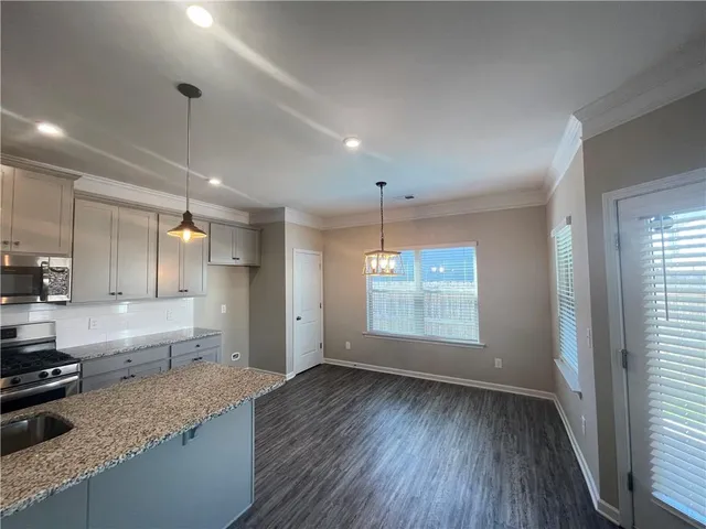 a view of a kitchen with a sink and dishwasher wooden floor