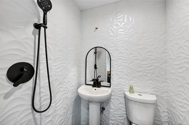 a bathroom with a toilet and a sink