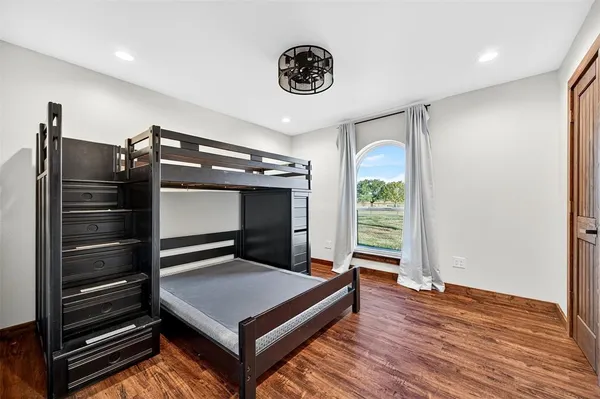 a living room with hard wood floors and a window