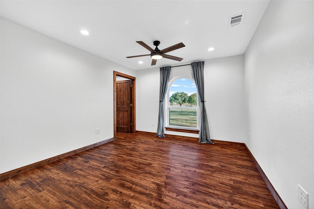 616 East Bells Boulevard Bells, TX 75414 - Photo 19 of 39 wooden floor in an empty room with a window
