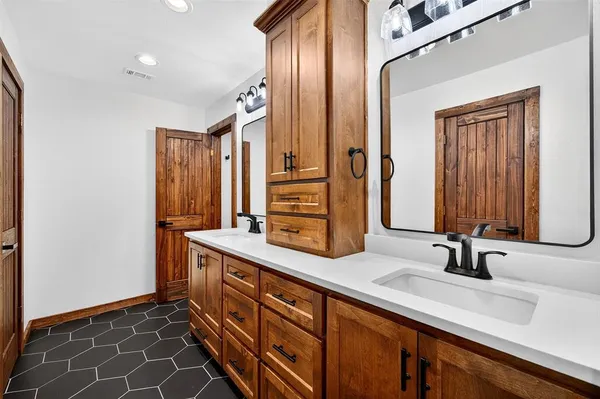 a bathroom with a double vanity sink mirror and
