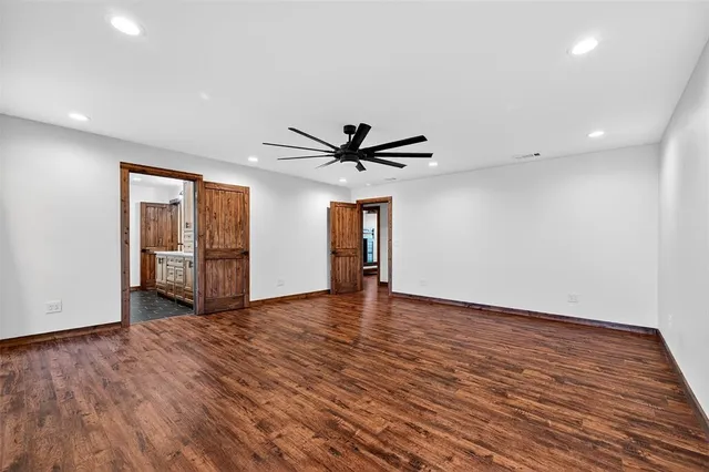 a view of room with wooden floor and ceiling fan