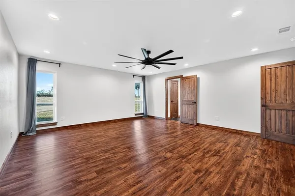 a view of livingroom with wooden floor and ceiling fan
