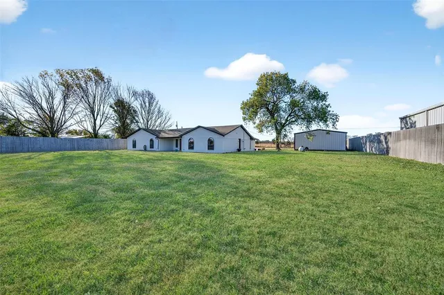 a view of a tree in front of a house