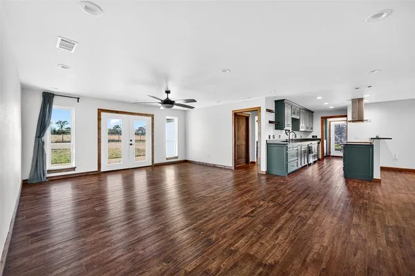 a view of a kitchen with a wooden floor and a kitchen