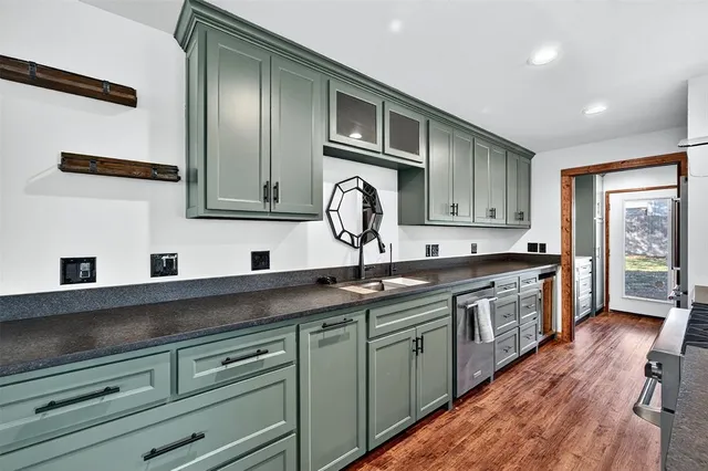 a kitchen with granite countertop stainless steel appliances and wooden cabinets