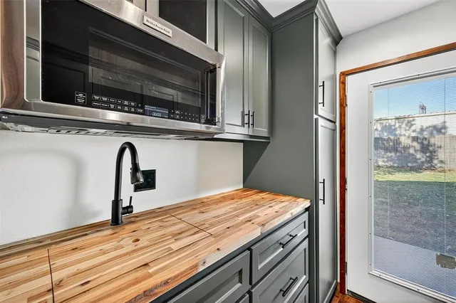 a kitchen view with wooden floor and a microwave oven