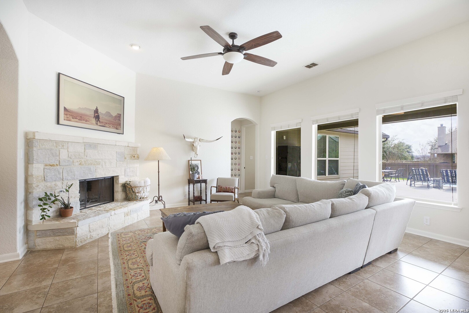3806 Brahman Road Bulverde, TX 78163 - Photo 11 of 36 a living room with furniture fireplace and a large window