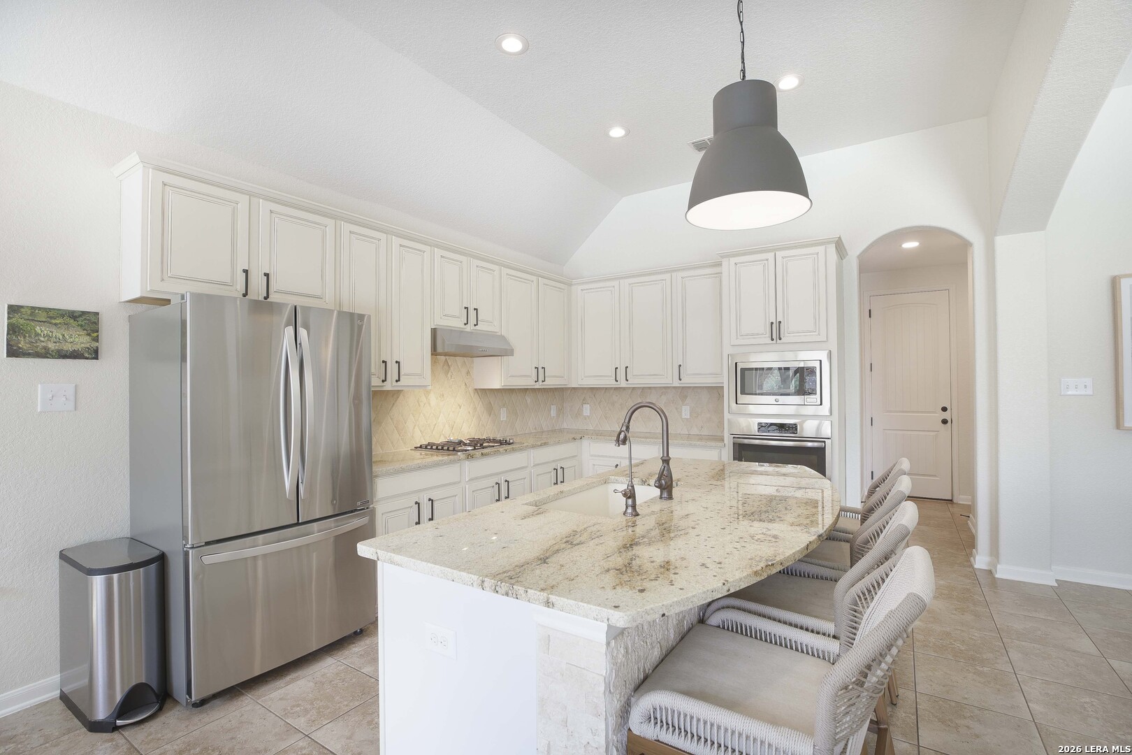 3806 Brahman Road Bulverde, TX 78163 - Photo 12 of 36 a kitchen with stainless steel appliances granite countertop a refrigerator a sink a stove a microwave and a refrigerator