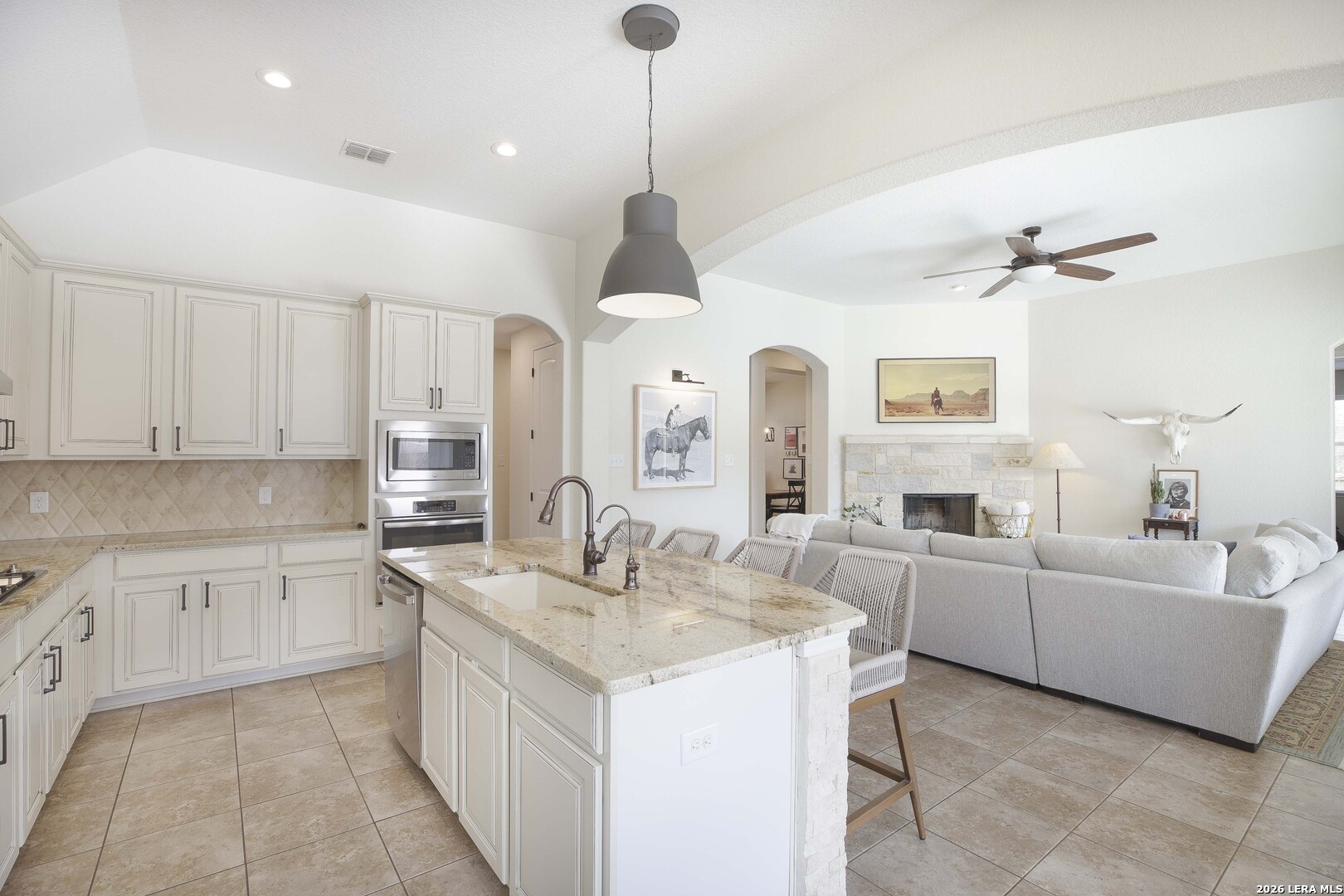 3806 Brahman Road Bulverde, TX 78163 - Photo 13 of 36 a large white kitchen with a sink and dishwasher with white cabinets