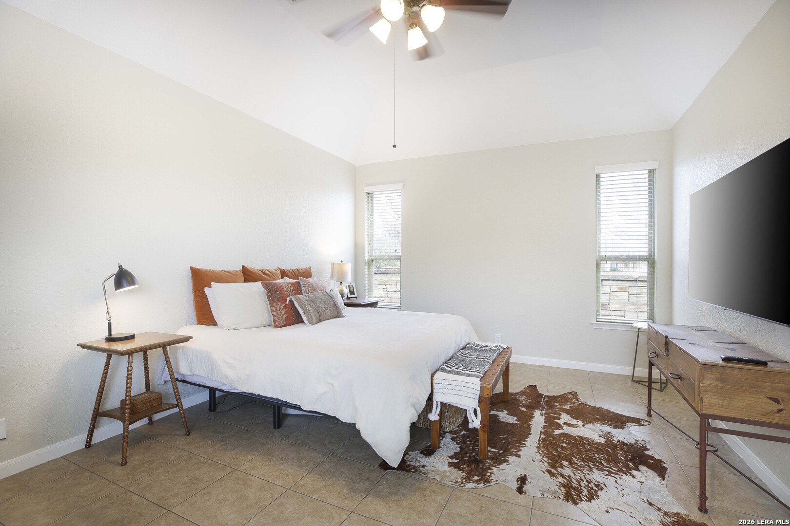 3806 Brahman Road Bulverde, TX 78163 - Photo 18 of 36 a bedroom with a bed and a flat screen tv