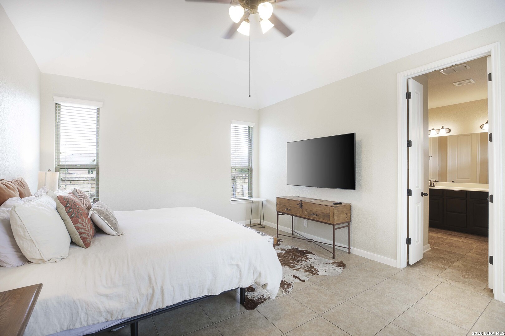 3806 Brahman Road Bulverde, TX 78163 - Photo 20 of 36 a bedroom with a bed and a flat screen tv