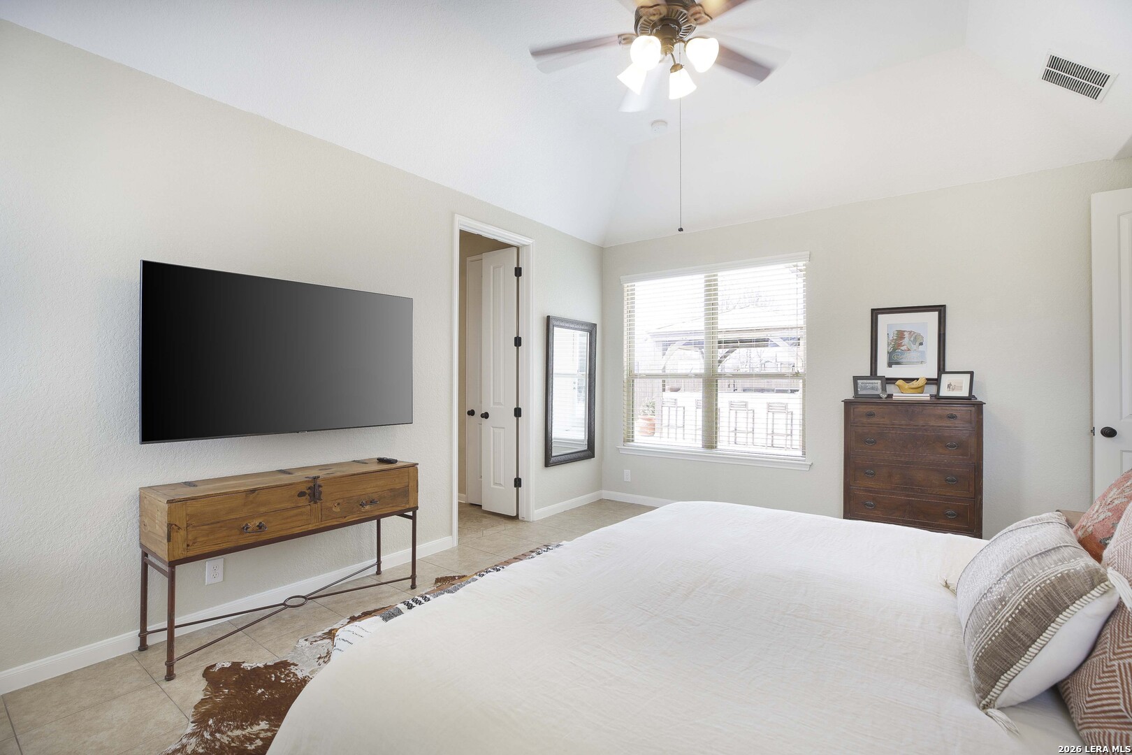 3806 Brahman Road Bulverde, TX 78163 - Photo 21 of 36 a bedroom with a bed and a flat screen tv