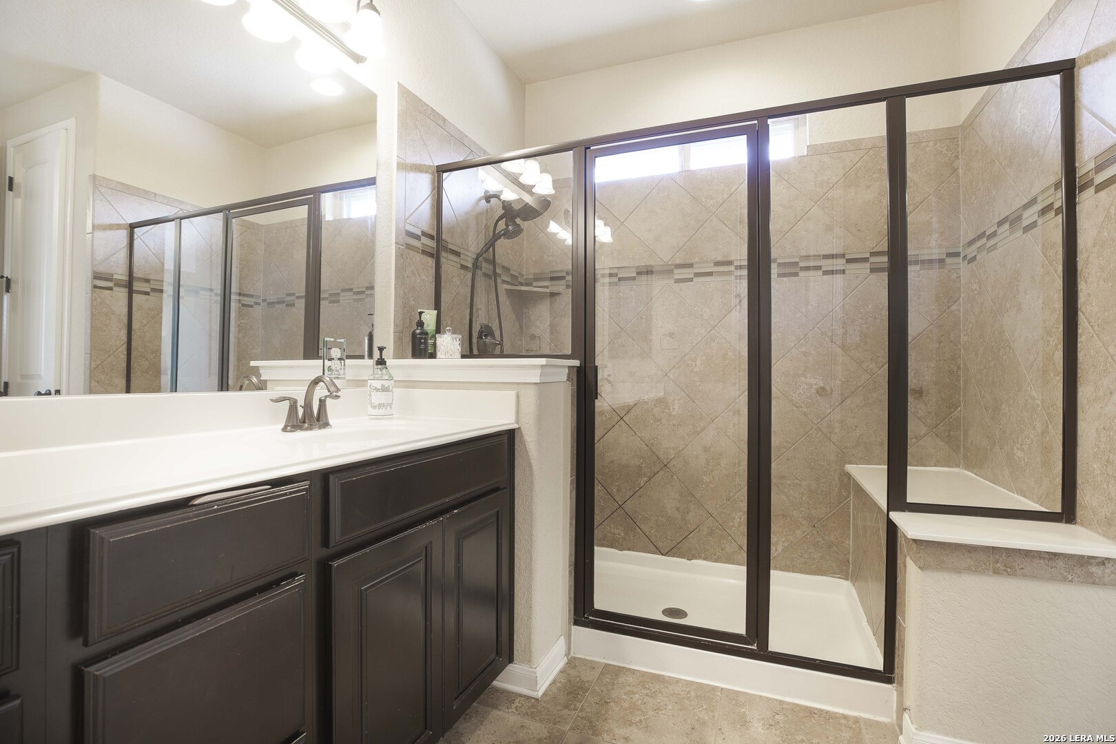 3806 Brahman Road Bulverde, TX 78163 - Photo 23 of 36 a bathroom with a double vanity sink and mirror