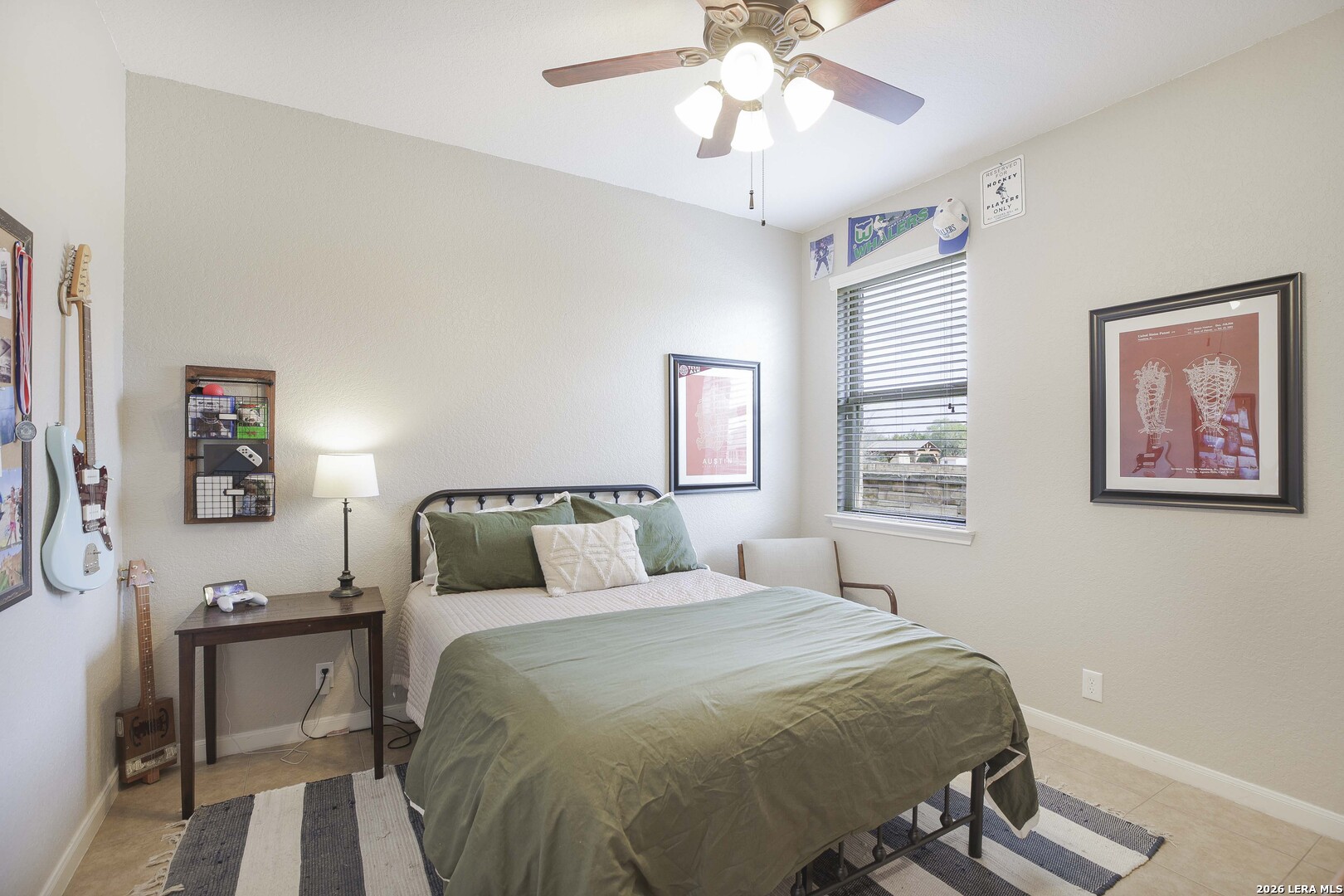 3806 Brahman Road Bulverde, TX 78163 - Photo 24 of 36 a bedroom with a bed and a chandelier