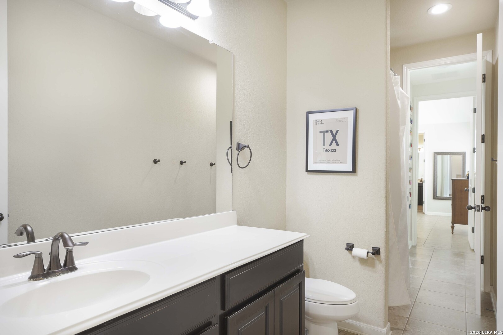 3806 Brahman Road Bulverde, TX 78163 - Photo 27 of 36 a bathroom with a sink a toilet a shower and a mirror