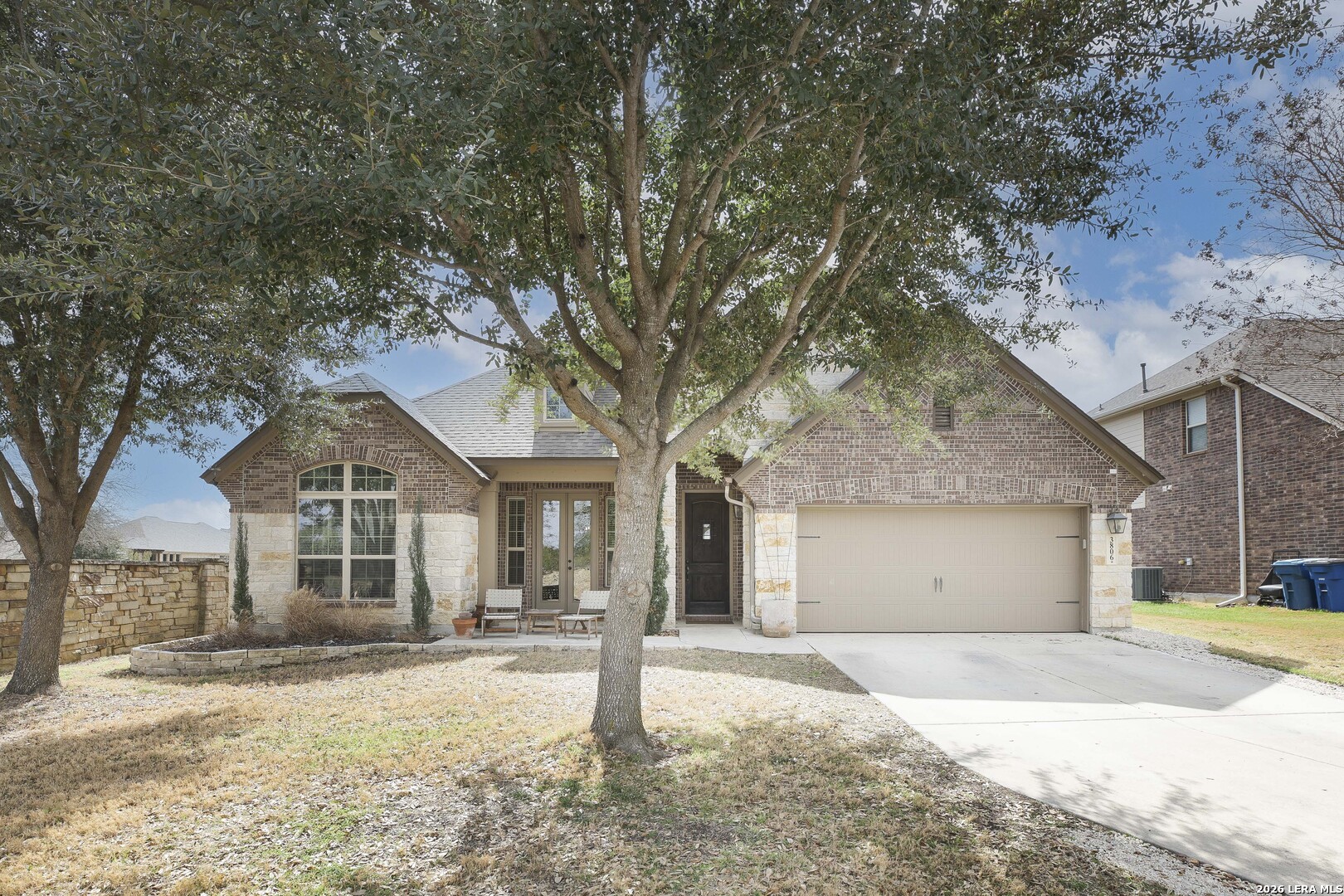 3806 Brahman Road Bulverde, TX 78163 - Photo 3 of 36 a front view of a house with a yard and garage
