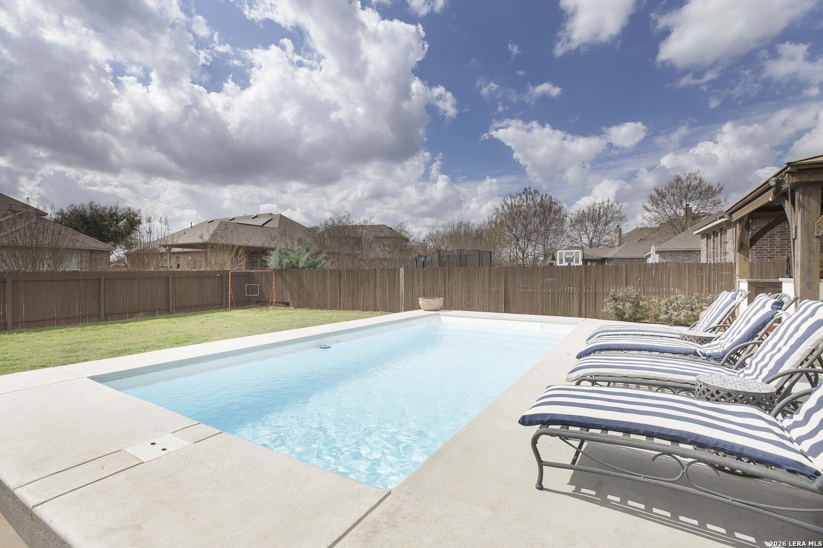 3806 Brahman Road Bulverde, TX 78163 - Photo 32 of 36 a view of swimming pool with seating space and wooden fence