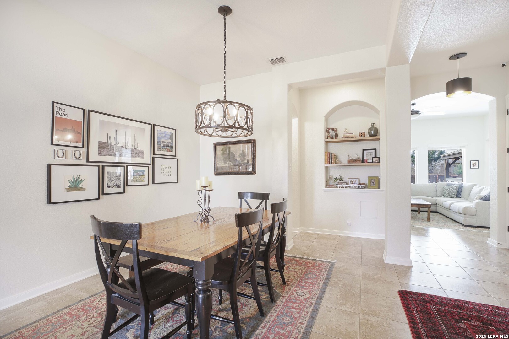 3806 Brahman Road Bulverde, TX 78163 - Photo 5 of 36 a view of a dining room with furniture a chandelier and wooden floor
