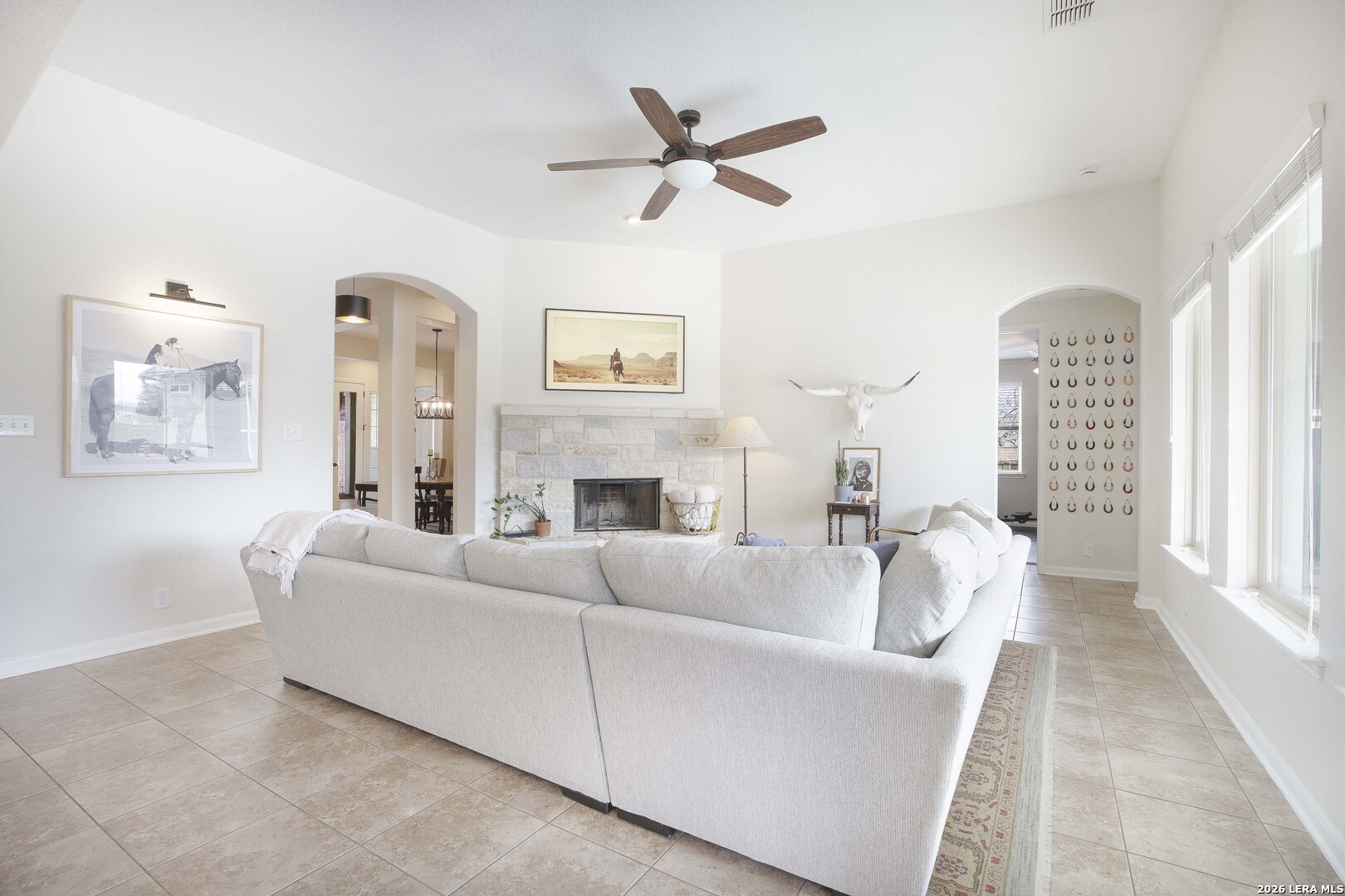 3806 Brahman Road Bulverde, TX 78163 - Photo 9 of 36 a living room with furniture a fireplace and a large window