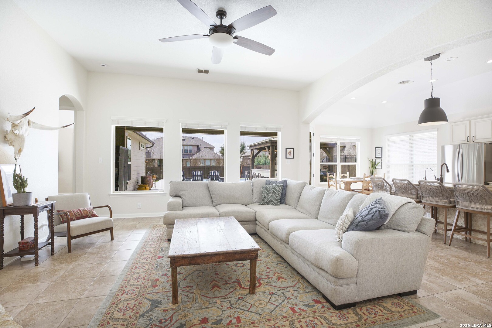 3806 Brahman Road Bulverde, TX 78163 - Photo 10 of 36 a living room with furniture ceiling fan and a window