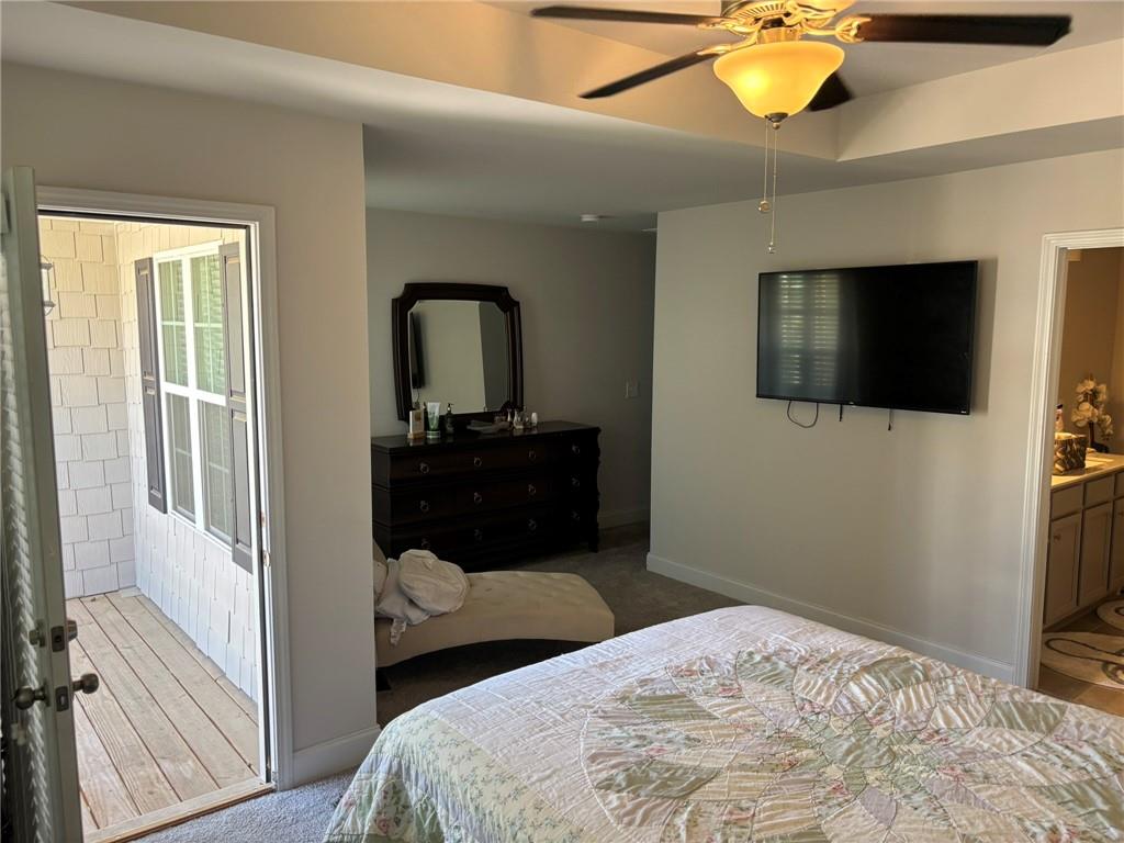 11208 Benton Loop Covington, GA 30014 - Photo 12 of 16 a bedroom with a bed and a flat screen tv
