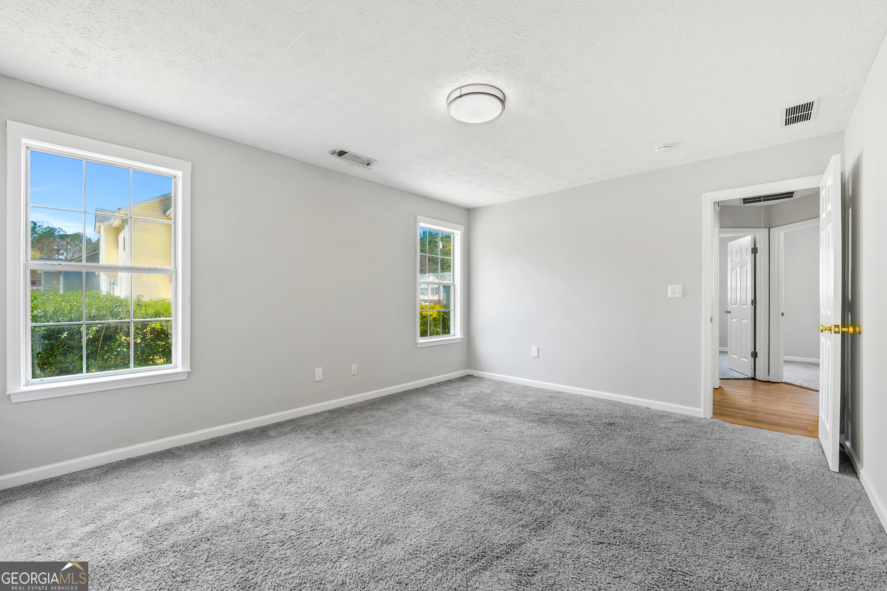 108 Nicki Court Hampton, GA 30228 - Photo 13 of 27 an empty room with windows and closet