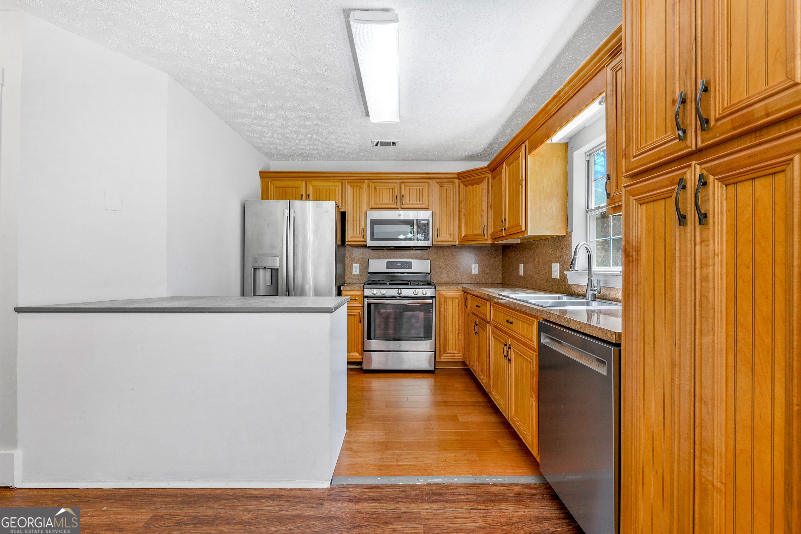 108 Nicki Court Hampton, GA 30228 - Photo 2 of 27 a kitchen with stainless steel appliances granite countertop a refrigerator a stove and a sink