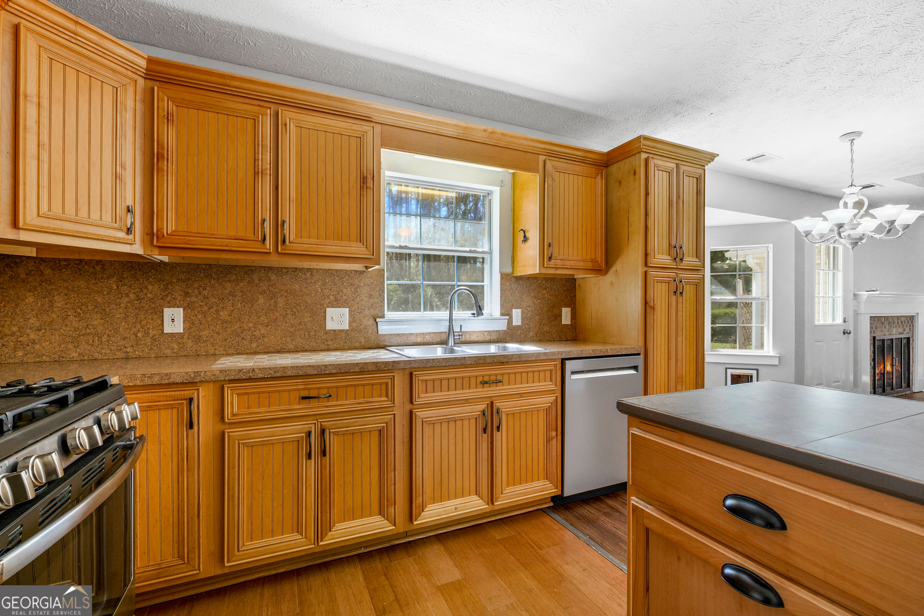108 Nicki Court Hampton, GA 30228 - Photo 4 of 27 a kitchen with granite countertop cabinets stainless steel appliances a sink and a window
