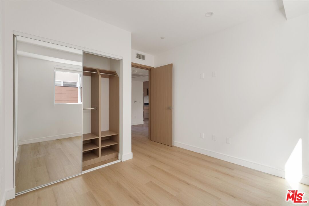 15211 1/2 Morrison Street Sherman Oaks, CA 91403 - Photo 13 of 16 an empty room with wooden floor and window