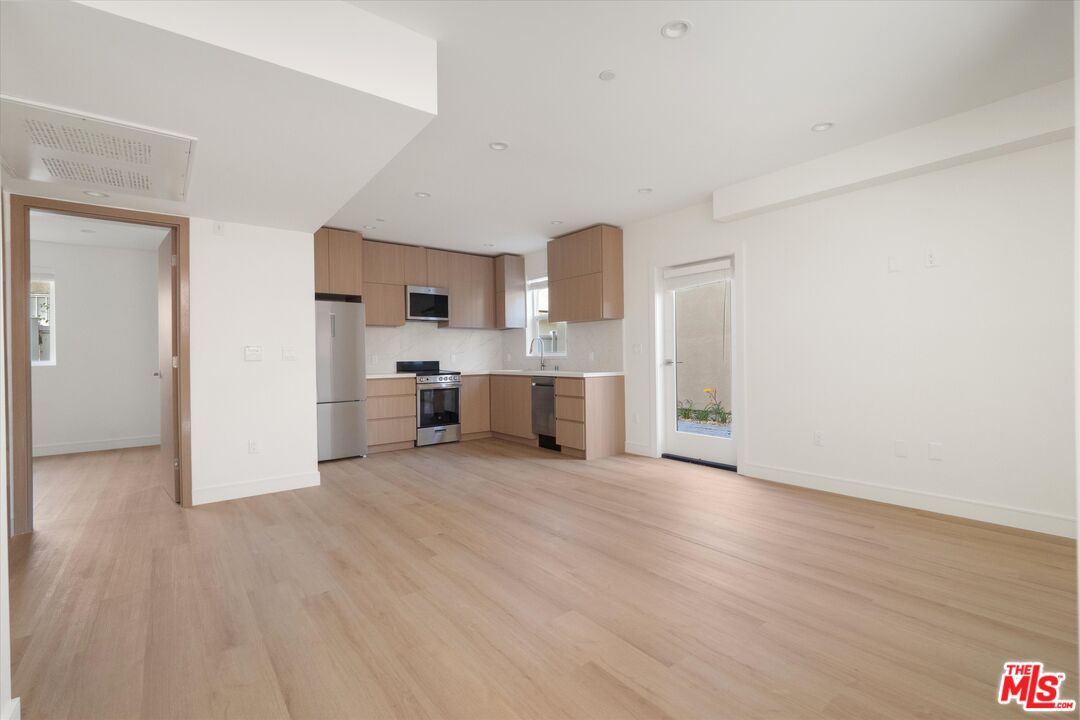 15211 1/2 Morrison Street Sherman Oaks, CA 91403 - Photo 2 of 16 a view of a kitchen with a sink cabinets and a living room