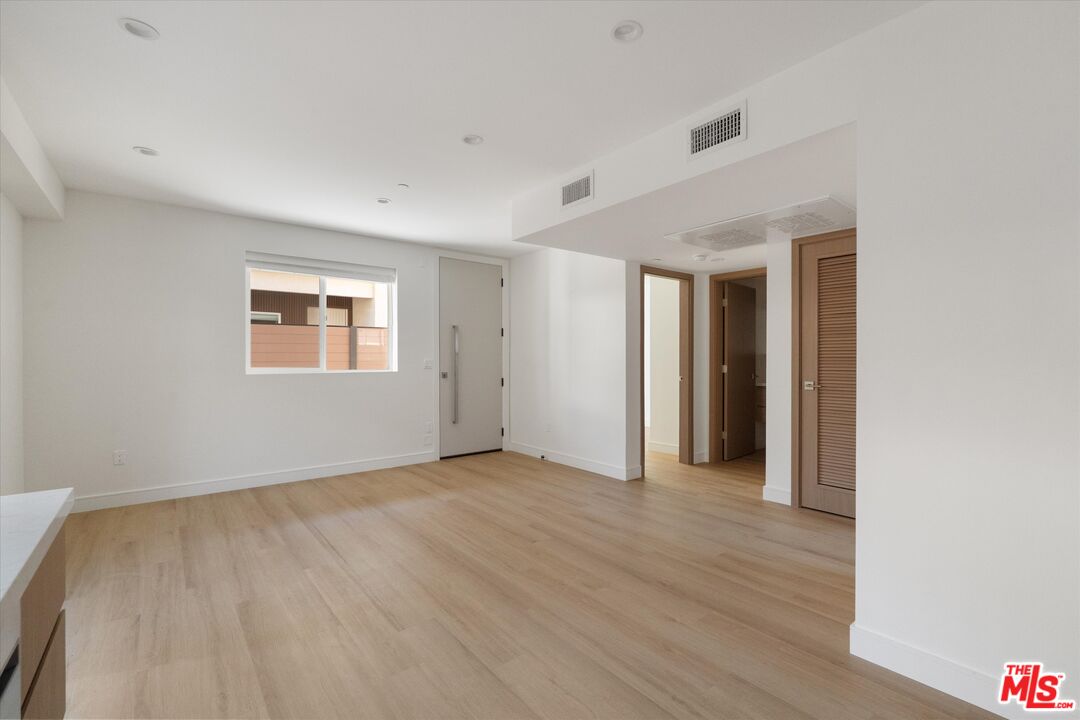 15211 1/2 Morrison Street Sherman Oaks, CA 91403 - Photo 5 of 16 an empty room with wooden floor and windows