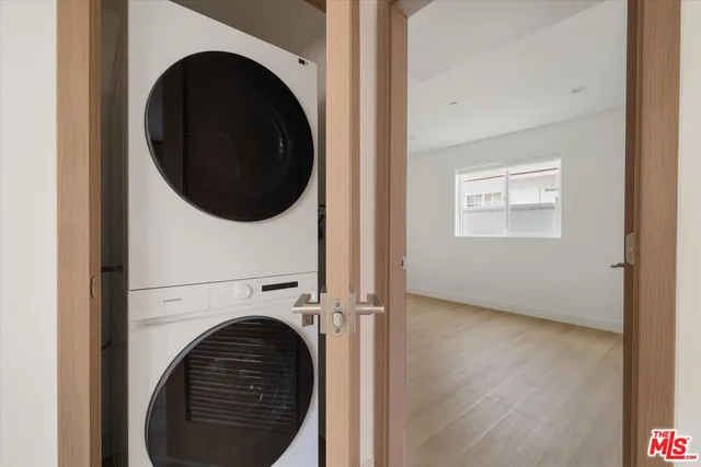 a view of a hallway with washer and dryer