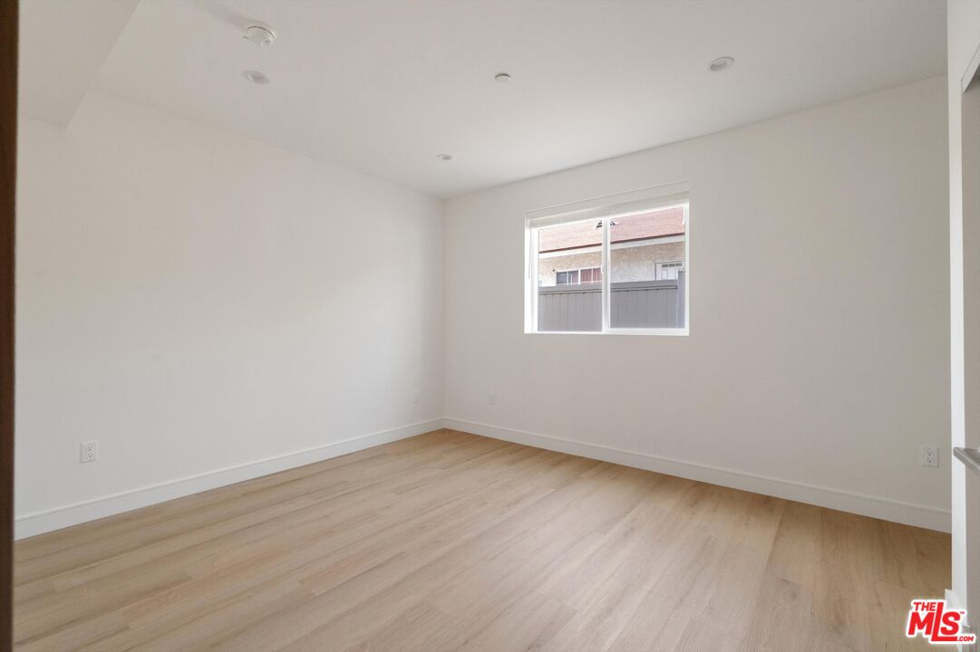 15211 1/2 Morrison Street Sherman Oaks, CA 91403 - Photo 9 of 16 wooden floor in an empty room with a window