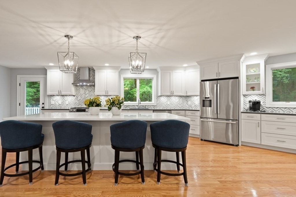 21 Elm Street Canton, MA 02021 - Photo 13 of 39 a kitchen with stainless steel appliances granite countertop table chairs stove refrigerator and cabinets