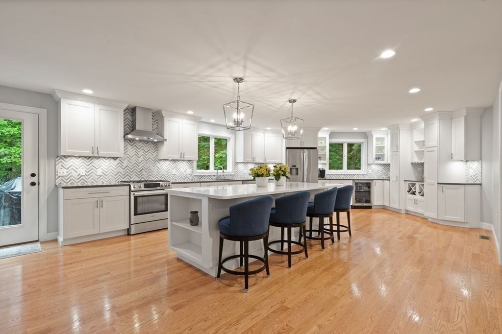 21 Elm Street Canton, MA 02021 - Photo 14 of 39 a kitchen with stainless steel appliances kitchen island granite countertop a table chairs sink and cabinets