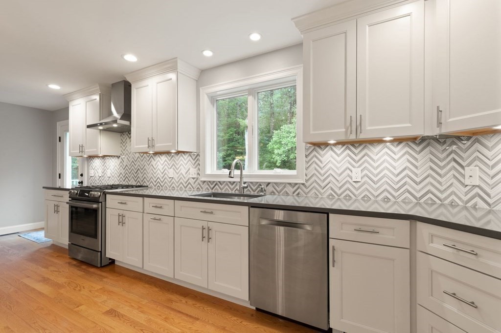21 Elm Street Canton, MA 02021 - Photo 18 of 39 a kitchen with granite countertop white cabinets and white appliances