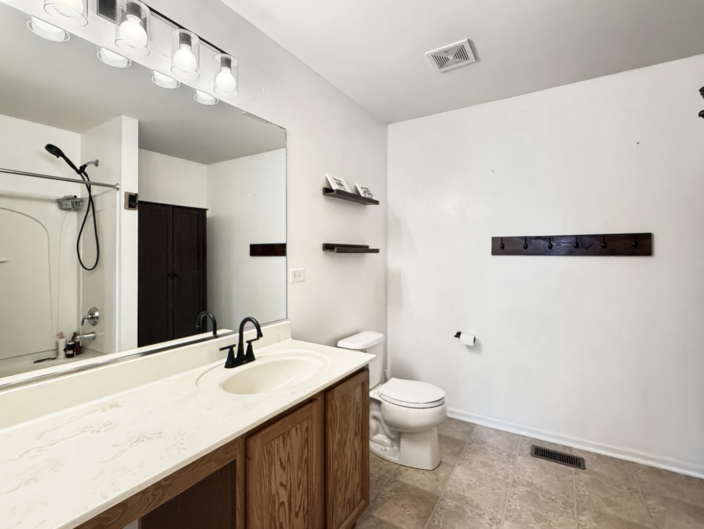 1114 Port Royal Road Pingree Grove, IL 60140 - Photo 12 of 25 a bathroom with a granite countertop sink a toilet and a mirror