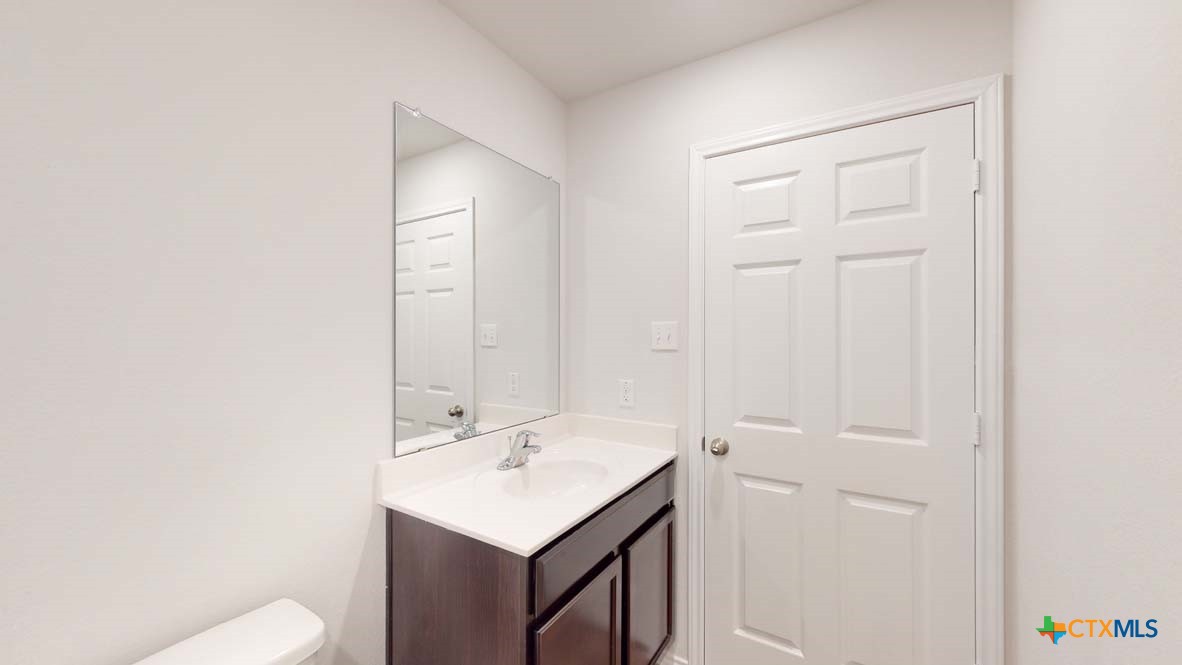 553 Hector Loop Georgetown, TX 78626 - Photo 20 of 21 a bathroom with a sink a toilet and vanity