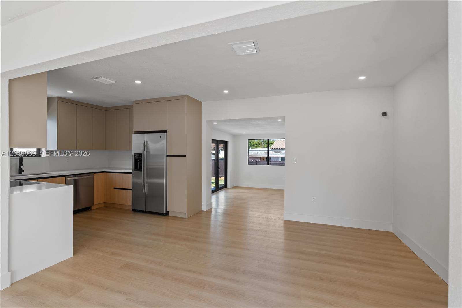 31 West 64th Street Hialeah, FL 33012 - Photo 17 of 49 a large kitchen with a refrigerator and a sink