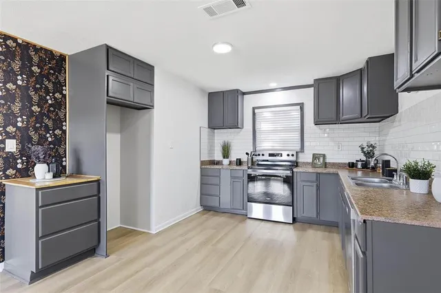 a view of a kitchen with a sink cabinets and wooden floor