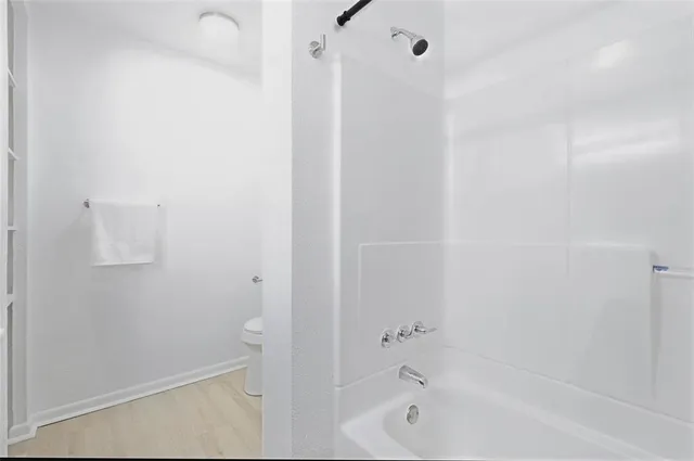 a bathroom with a bathtub and shower