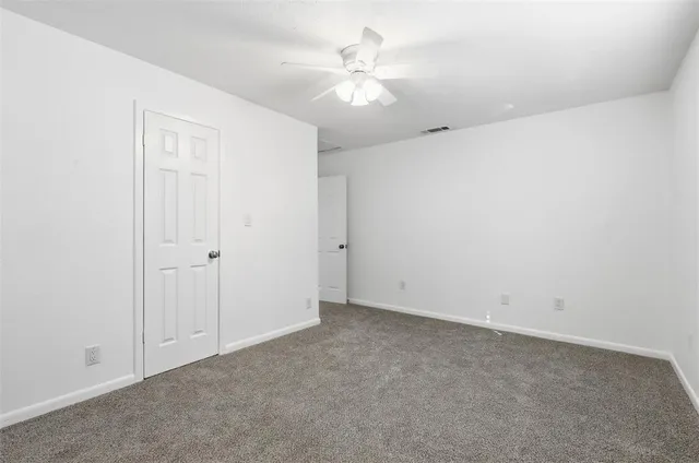 a bathroom with a sink a toilet and shower curtain