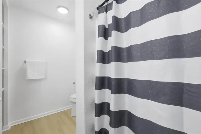 an empty room with a chandelier fan and a chandelier fan