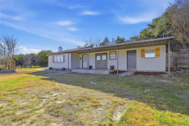 a view of a house with swimming pool and a yard