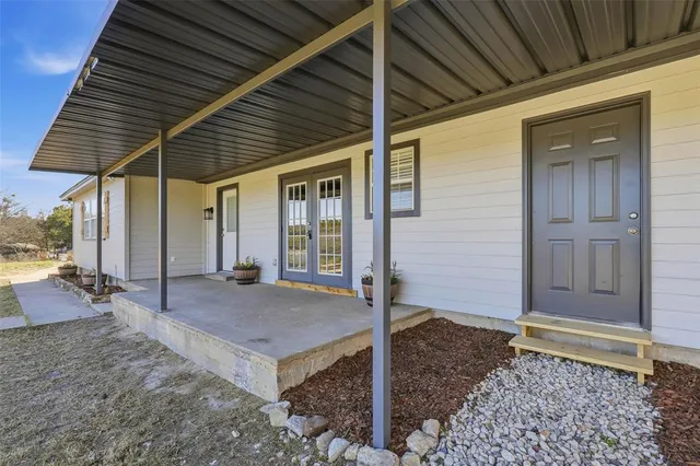 a living room with furniture a window and a chandelier