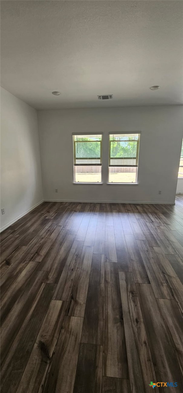 2513 Rollett Drive Temple, TX 76504 - Photo 4 of 6 an empty room with wooden floor and windows