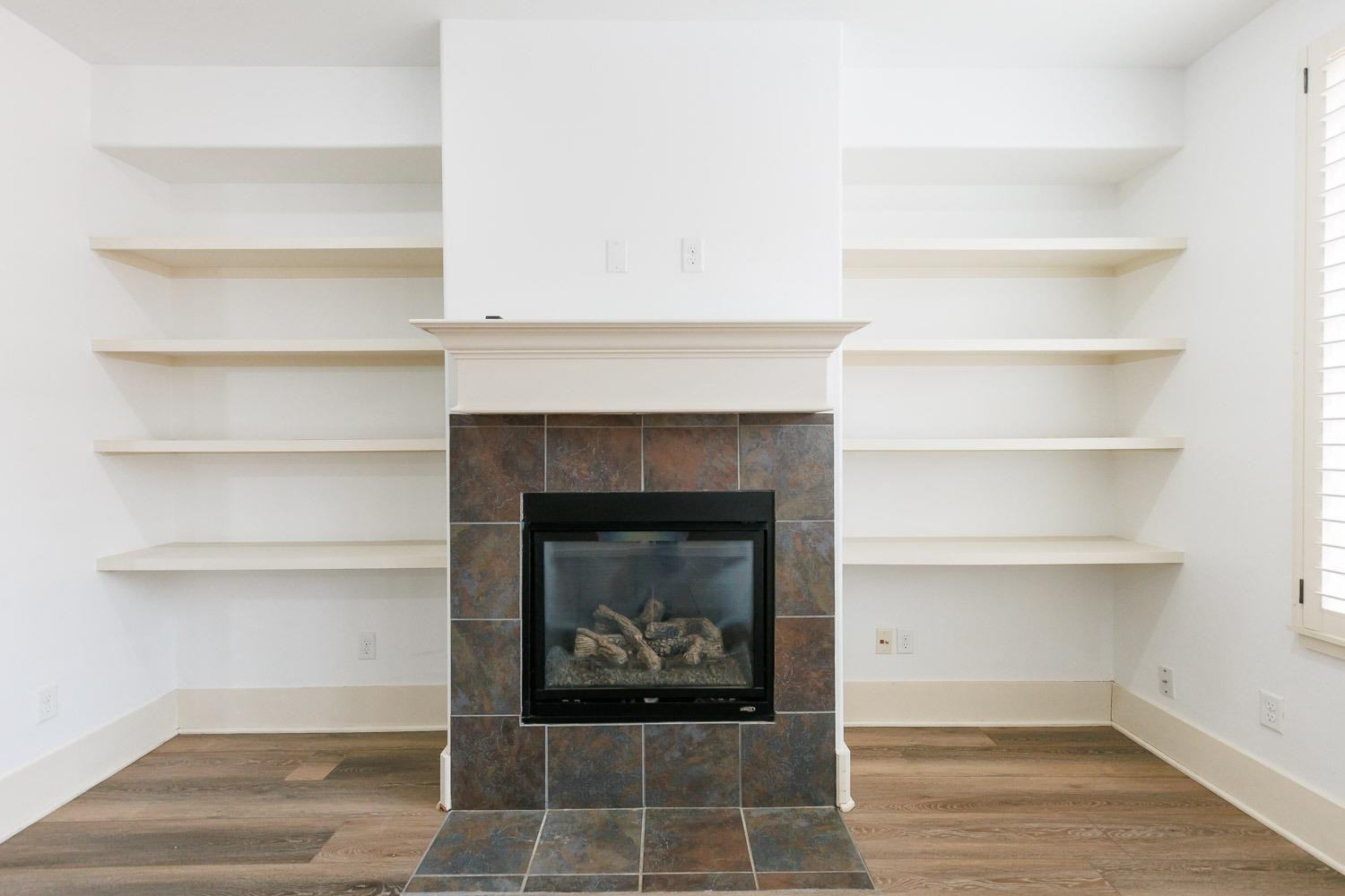 4612 121st Street Lubbock, TX 79424 - Photo 11 of 26 a living room with a fireplace and a walk in closet